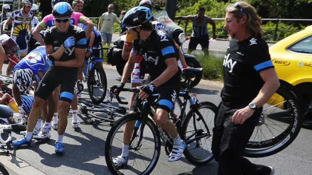 Down and out: Edvald Boasson Hagen (second from left) stands up after crashing on stage 12.