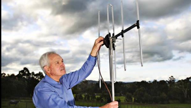 Graeme Redman from Pure Australasia adjusts an antenna.