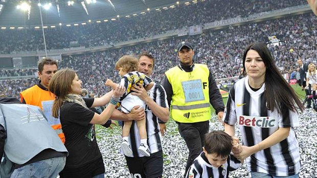 Skipper Alessandro Del Piero celebrates with his wife Sonia Amoruso (right) after Juventus won its 28th Serie A title.