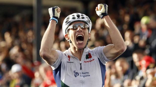 Oh yeah: Portugal's Rui Costa celebrates as he crosses the line as the world road race champion.