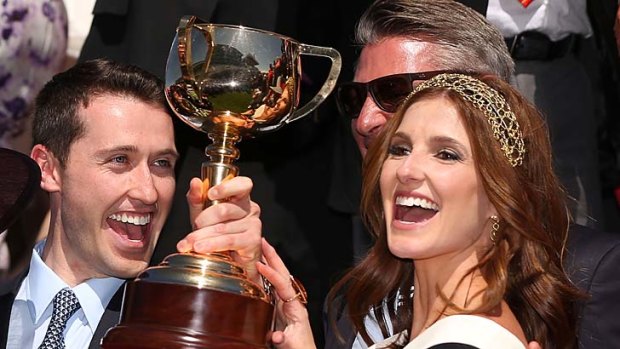 Trainer Gai Waterhouse's son Tom and daughter Kate hold up the Melbourne Cup after Fiorente's win.