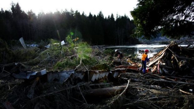 Search and rescue personnel continue working the area of Saturday's mudslide.