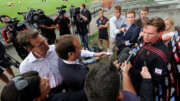 On the outer, and under pressure: Essendon coach James Hird faces the media.