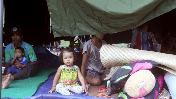 A family rests in a tent at an evacuee camp in Klungkung, Bali, Indonesia, on Sunday.