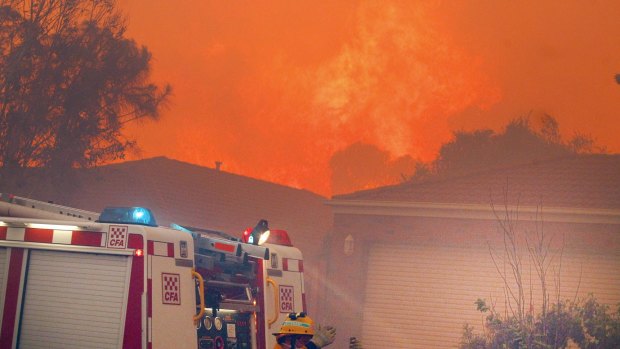 A bushfire nears houses at Hastings.