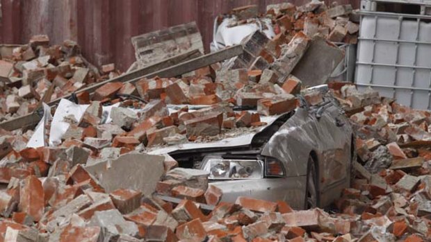 Destruction ... a car sits crushed in Christchurch.