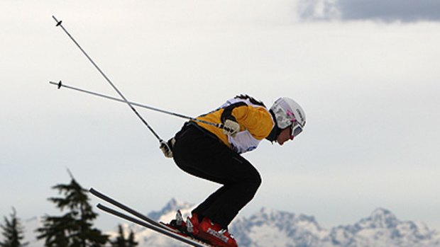 Flying  ... Jenny Owens takes to the air during a ski cross qualification event  near Vancouver last year; inset, the 31-year-old says the many bruising spills are just part of the sport.
