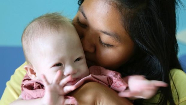 Surrogate mother Pattharamon Janbua comforts Gammy in a Thai hospital.