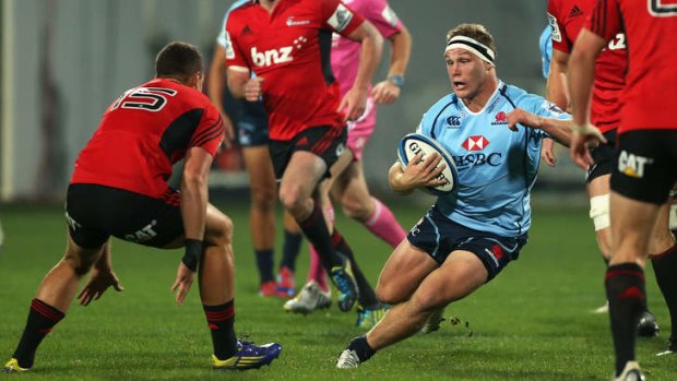 Running riot: Michael Hooper charges at Crusaders fullback Israel Dagg before giving him the slip on Friday night.