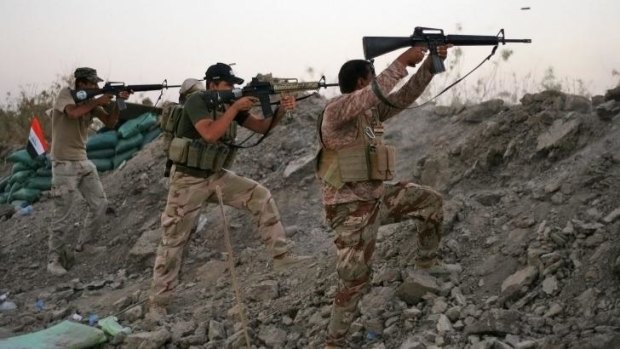 Iraqi Shiite militiamen clash with militants from the Islamic State.
