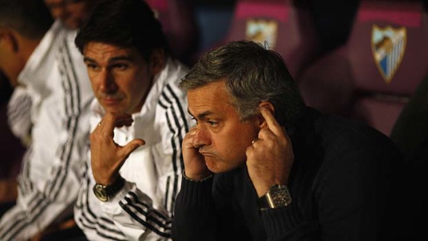 Real Madrid coach Jose Mourinho (right) watches the match against Malaga.