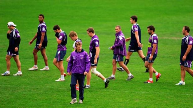 Fire sale ... the Storm put their heads down at training under coach Craig Bellamy in Melbourne yesterday.