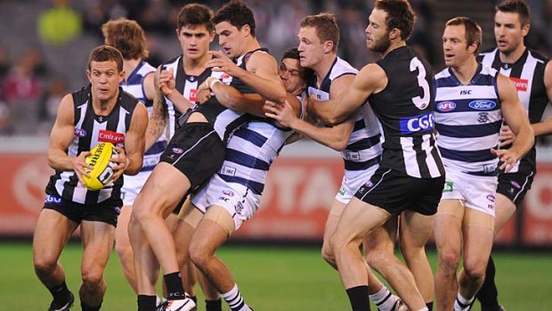 On the move: Luke Ball beats a band of Collingwood and Geelong players to the ball at the MCG on Saturday night.
