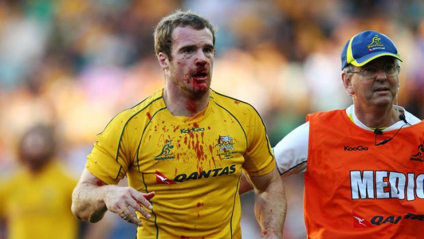 Pat McCabe of the Wallabies is taken from the field against Wales at Allianz Stadium on June 23.