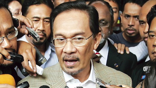 Anwar Ibrahim speaks to the media shortly before being arrested. He had been about to go to Kuala Lumpur police headquarters for questioning over sexual assault allegations. PICTURE: REUTERS