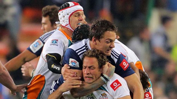 Cheetahs centre Andries Strauss is tackled by Stormers flanker Rynardt Elstadt.