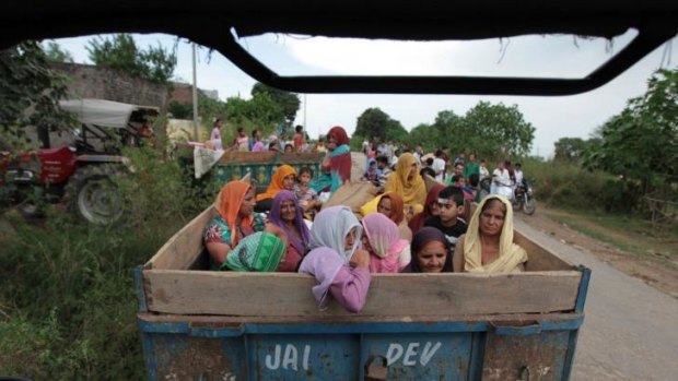 Fleeing: Indian villagers prepare to leave the disputed region of Kashmir after a cross-border exchange between Indian and Pakistani soldiers.