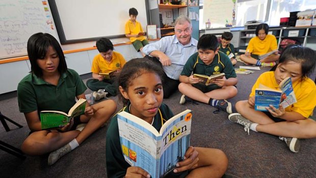 Sunshine North Primary School students read with principal Ken Ryan.