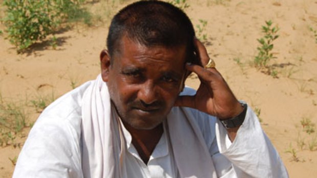 Chatan Singh with his failed crop in Haryana.