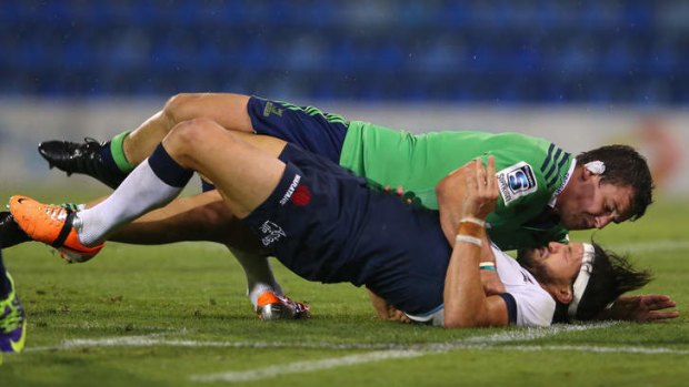 Down and out: Waratahs utlity Adam Ashley-Cooper is neutralised by John Hardie of the Highlanders during Friday's trial match in Newcastle.