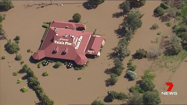 The landmark Yatala Pies store south of Brisbane is surrounded by floodwater.