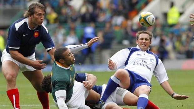 Bryan Habana gets his pass away as referee Bryce Lawrence takes a fall.