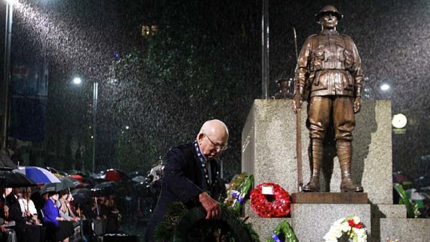 Waiting for the sunrise... Wal Scott-Smith, 89, the chief cenotaph attendant, in the rain at the Anzac Day dawn service at the Martin Place Cenotaph.