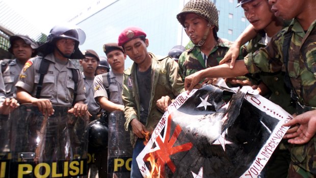 Indonesian children burn a mock Australian flag in 1999 in protest against Australia's intervention in East Timor.