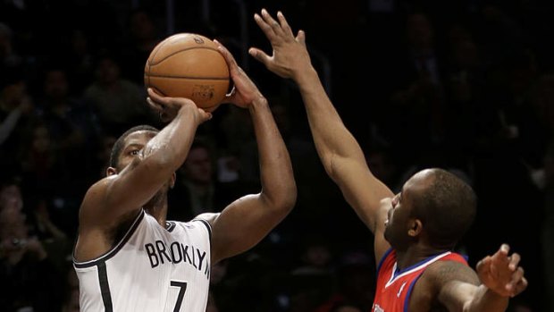 Brooklyn Nets guard Joe Johnson takes a shot over Philadelphia 76ers opponent James Anderson at the Barclays Center.
