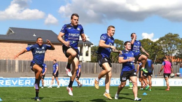 Leap of faith: Bulldogs players warm-up at training on Monday.