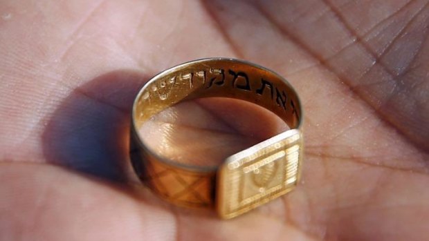 A golden ring with a Hebrew inscription is shown after being discovered at the Nazi's Sobibor death camp. Many personal items of victims were found at the bottom of a well.