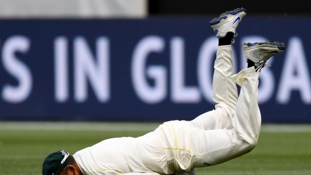 Usman Khawaja dives to catch Stuart Broad - and drives his face into the dirt.