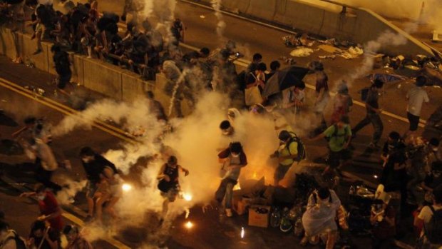 Riot police fire teargas to disperse protesters outside the government headquarters in Hong Kong.