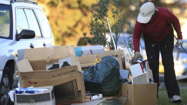 One man's trash is another man's treasure: A hopeful hunter sifts through rubbish piles waiting for a council hard waste clean-up in South Coogee.