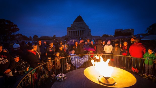 MELBOURNE, AUSTRALIA - APRIL 25:  The crowd at the eternal flame during the ANZAC Day dawn service at the Shrine of Remembrance on April 25, 2015 in Melbourne, Australia. This year marks the 100th anniversary of the ANZAC landings at Gallipoli.  (Photo by Chris Hopkins/Fairfax Media)