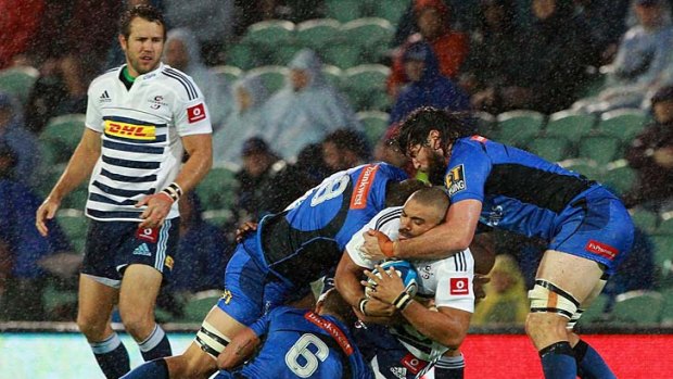 Stormers winger Bryan Habana is gang-tackled by Ben McCalman, Matt Hodgson and Toby Lynn of the Force.