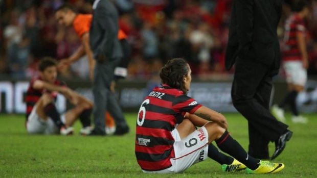 Inconsolable: Wanderers players were crestfallen after the grand final loss.