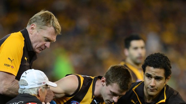 Down for the count: Whitecross is helped after hurting his knee in the 2012 finals series.