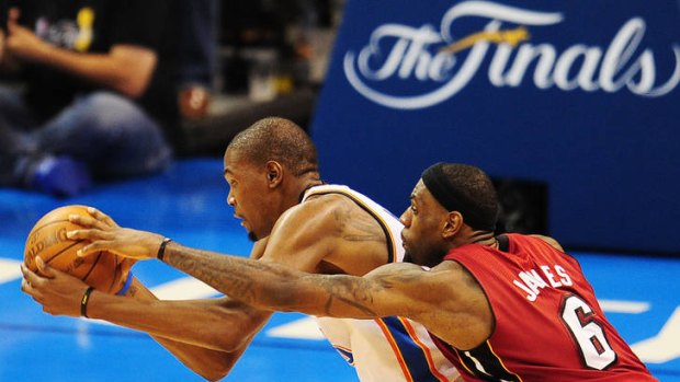 Miami Heat's LeBron James (right) puts pressure on Oklahoma City Thunder's Kevin Durant in game one of the NBA finals.