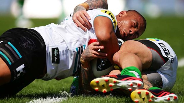 Try time: Penrith's Sika Manu outmuscles Raiders fullback Josh Dugan to score one of the Panthers' five tries at Centrebet Stadium on Sunday.