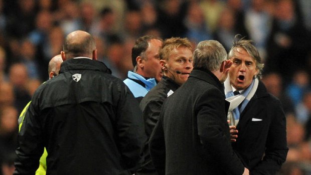 Derby rage ... Manchester City's manager Roberto Mancini (R) exchanges words with Manchester United manager Alex Ferguson.