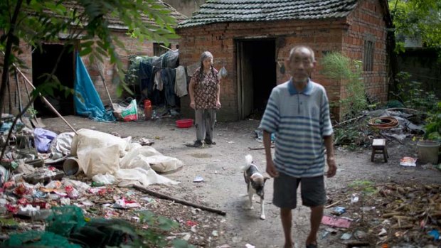 Hou Guiying, 71, and her husband, Ma Jinling, 81, outside their home in the village of Luzhai.