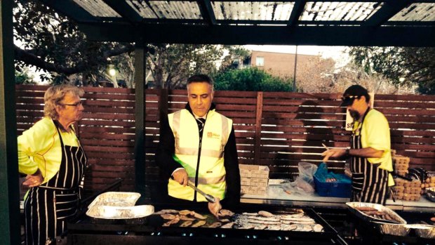 Australia Post chief executive Ahmed Fahour helping out at a staff barbecue. 