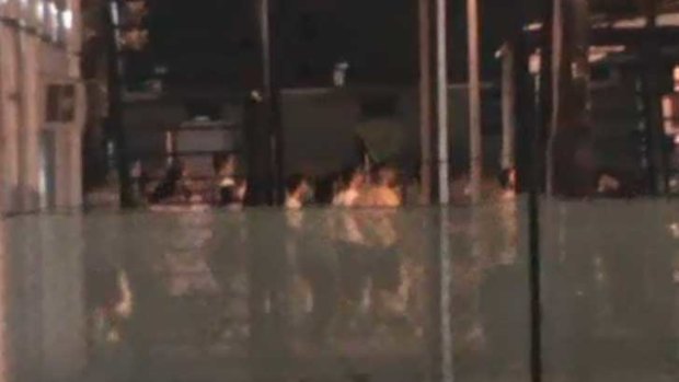 A screen grab, taken from the ABC, of riots on Manus Island.