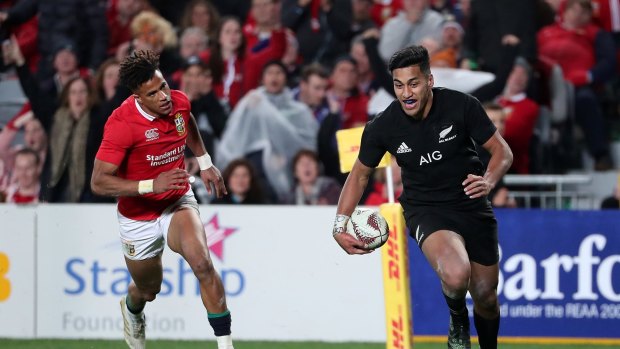Rieko Ioane of the All Blacks scores a try with Anthony Watson of the Lions chasing.