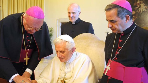 Pope Benedict XVI uses an iPad to tweet a message praising Jesus and announcing the launch of a new Vatican website.