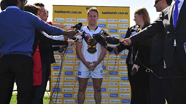 Sam Mitchell, clad in the new clash guernsey, speaks to the media yesterday.