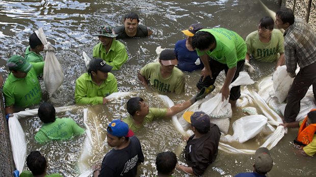 Workers build a dam from sandbags last month as they attempt to seal off a canal to search for remnants of an explosive device thrown into the canal.