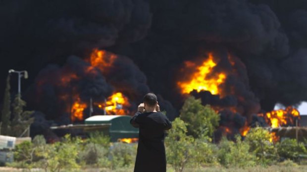 A Palestinian man witnesses the Gaza power plant go up in flames.