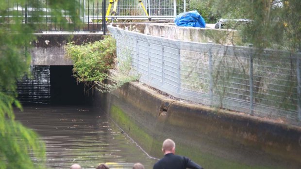 Police divers search the Meadowbank canal where  body parts were found in  a suitcase.